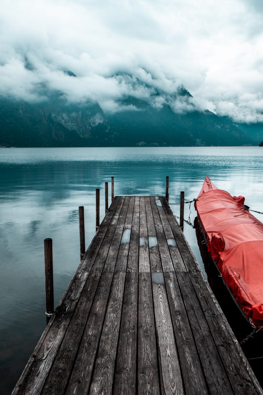 Moody lake with wooden dock